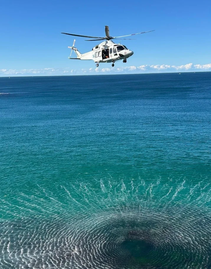 Rescue helicopter hovering above Queenscliff Headland